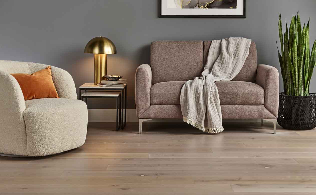 Living room with light hardwood floor and orange pillow.